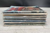 Stack of all magazines in plastic sleeves, showing quantity and general condition