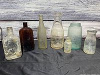All seven vintage and antique bottles and jars