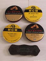 Group shot of four advertising tins and leather cleaner pad