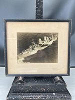 Full view of framed photograph on stand