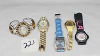 Group shot of all five watches with lot number card