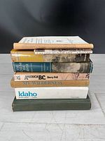 Stack of seven frontier and wilderness books showing spines