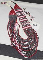 Full view of woven seed bead necklace and matching earrings