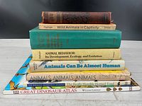 Stack of eight animal science books showing spines and titles