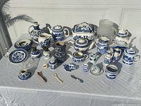 Full layout of 31 blue & white transferware pieces on table
