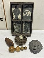group shot of shadow box, nest, duck carving, mask and four balls