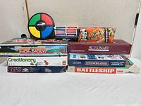 Overall lot showing stacked board games, Simon unit, playing cards and Jenga