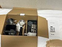 Open accessories box showing all components