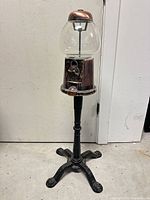 Full view of gumball machine on pedestal base