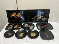 All ten Couroc pieces displayed: two large rectangular trays and eight assorted plates/platters