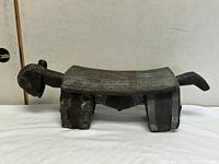Full side view of carved wooden stool