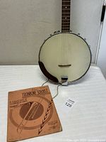 Front view of Kent banjo with music book