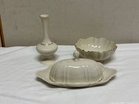 Group shot of bud vase, covered butter dish, scalloped bowl