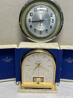 Atmos mantel clock and wall clock side by side