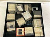 Top view of open box showing numerous stacks of mounted slides in plastic cubes and loose mounts