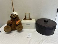 Group shot of bear, bread box, mirror, hat box