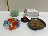 Group view of five glass bowls in assorted colours and shapes