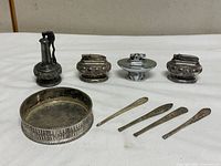 Group shot of four table lighters, round etched dish, and four picks