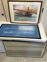 Group shot of all three framed items: USS Missouri print, blueprint, seismograph chart