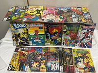 Eighteen sample comics displayed on two tiers highlighting variety of Marvel and DC titles