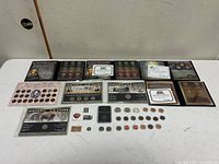 Overall view of all coin sets, loose coins, stamps and token