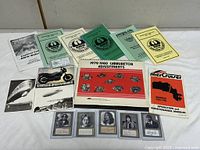 Group shot of manuals, pamphlets, postcards and Beatles cards