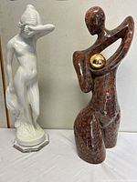 Front view of both sculptures showing relative size, colors, and finishes