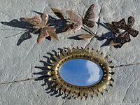 Butterfly vine and sunburst mirror front view