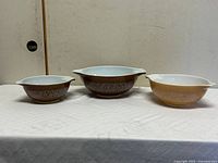 All three Woodland Brown Pyrex Cinderella bowls lined up