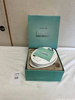 Open teal Remington iLIGHT Ultra box showing base unit seated in molded insert with paperwork