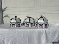 Front view showing all three matching stained glass pendant lamps