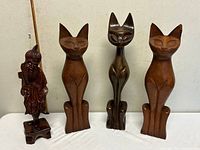 Front view of all four wooden sculptures