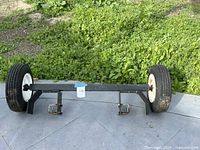 Full view of axle assembly with both wheels and mounting brackets