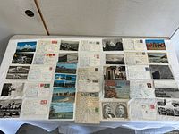 Tabletop view of all postcards laid out front and back