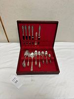 Flatware set in open wooden case showing interior layout