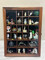 Front view of closed wooden shadowbox filled with figurines