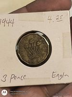 Reverse of 1944 threepence in holder showing thrift design and date