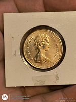 Obverse of coin in holder showing Queen Elizabeth II