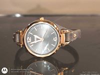 Front view of Fossil ES3077 watch showing gold-tone case, black dial, leather strap