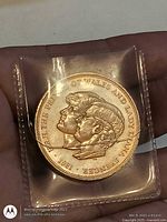 Coin in 2×2 plastic, Charles and Diana side visible