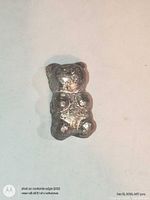 Front view of pewter teddy bear ingot