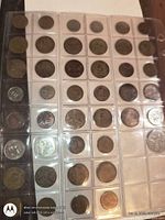 full view of plastic page showing four columns of coin pockets with coins
