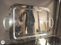 Front view of rectangular silver-plated tray with handles