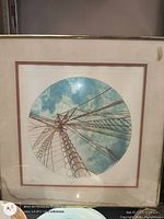 Framed circular lithograph of sailboat mast, front view