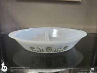 Side view showing full dish profile and green floral pattern