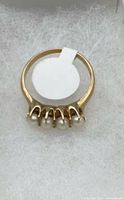 Top view of ring showing four pearls and claw prongs