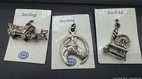 All three sterling charms on cards