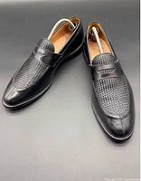 Top view of both loafers showing woven vamp and overall condition