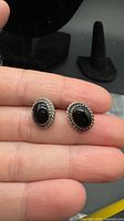 Front view of both sterling silver black onyx stud earrings