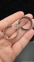 Pair of Italian silver hoop earrings shown together